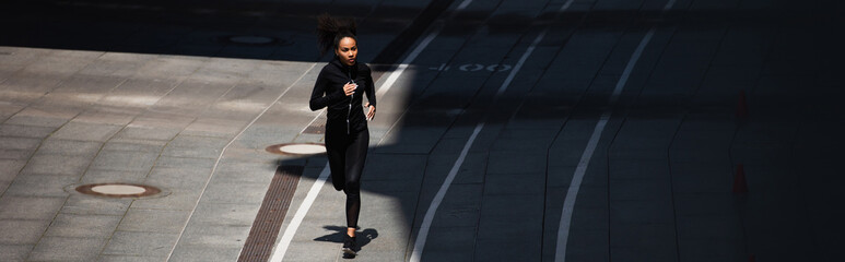 African american sportswoman running on track, banner