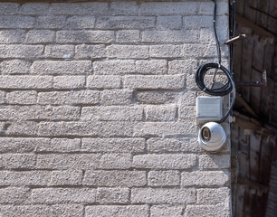 hemispherical shape, surveillance camera connected to the network and mounted on the wall of a brick house