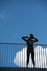 Low angle view of african american sportswoman standing on bridge