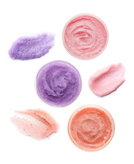 Set with different body scrubs on white background, top view