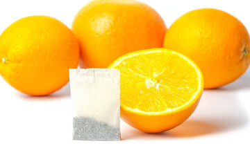 Orange tea in a bag. Tea bag and oranges on a white background.