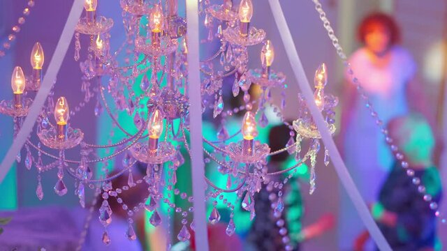4k, elderly people dancing at a party, view through a chandelier in a restaurant, blurred 