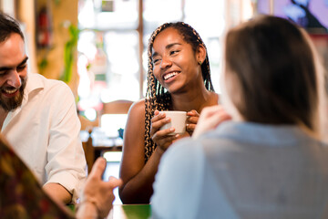 Diverse group of friends enjoying a cup of coffee together.