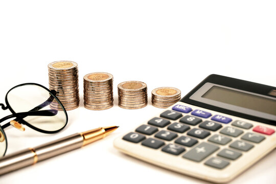 busines, finance, money and bookkeeping concept - calculator, pen, eyeglasses and thai coins on white background.