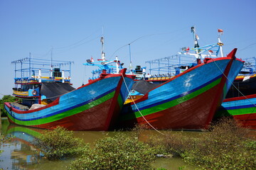 A wooden fishing boat is parked at the mouth of the Juwana River, Pati, Central Java, Indonesia.