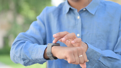 Hands Close Up of African Woman using Smart watch 