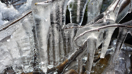 Beautiful icicles on a frozen mountain stream