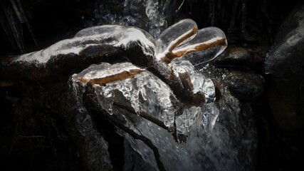 Beautiful icicles on a frozen mountain stream
