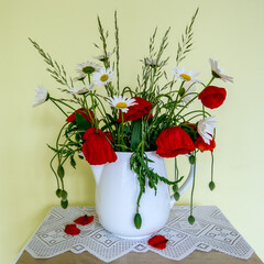bouquet of daisies and poppies in a vase 