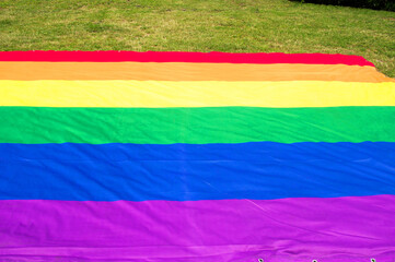 Rainbow flag, a symbol for the LGBT community on a grass field