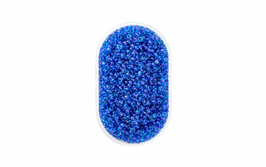 Plastic box with blue round beads isolated on white background.
