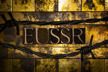 EUSSR text between barbed wire on vintage textured grunge gold and copper background