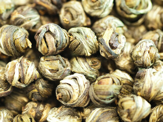 Fototapeta na wymiar Leaves of Chinese green tea twisted in pearls, close-up