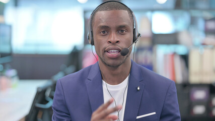 Portrait of Young African Businessman Talking with Headset