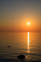 Sunset by the sea. Baltic Sea. Tourism and meditation accompanied by the setting sun.