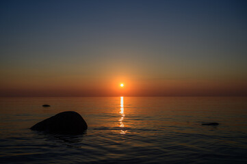 Fototapeta na wymiar Sunset by the sea. Baltic Sea. Tourism and meditation accompanied by the setting sun.