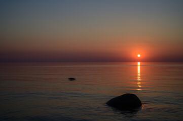 Fototapeta na wymiar Sunset by the sea. Baltic Sea. Tourism and meditation accompanied by the setting sun.
