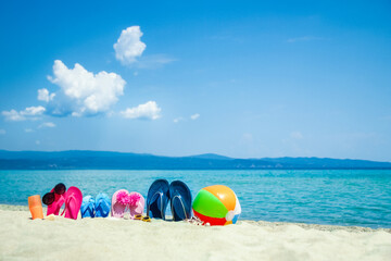 Obraz premium beautiful slippers in the sand by the sea greece on nature background