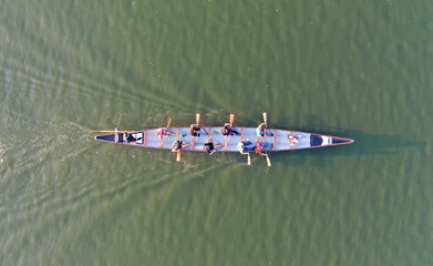Aerial drone top view of sport canoe rowing team of athletes competing