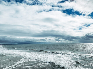 Still image of a lone seagull riding the wind above the waves of the ocean