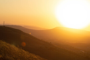 Sunset on hilly terrain in summer. High quality photo
