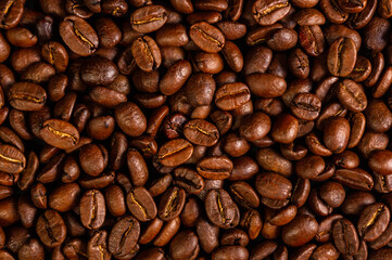 Natural background for Cafe menu or brochure template - macro photo of brown roasted coffee beans, close up