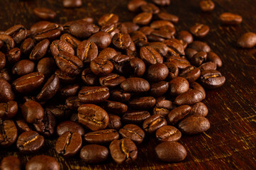 Fototapeta premium Natural background for Cafe menu or brochure template - macro photo of brown roasted coffee beans, close up