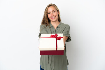 Fototapeta premium Young caucasian woman isolated on white background pregnant and holding a gift