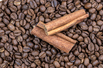 cinnamon sticks on the coffee roasted beans background in Brazil