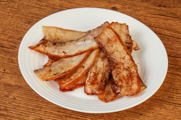 Roasted juicy bacon in the plate