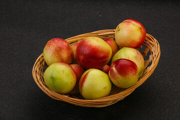 Sweet small nectarines in the basket