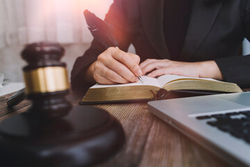 Business and lawyers discussing contract papers with brass scale on desk in office. Law, legal services, advice, justice and law concept picture with film grain effect