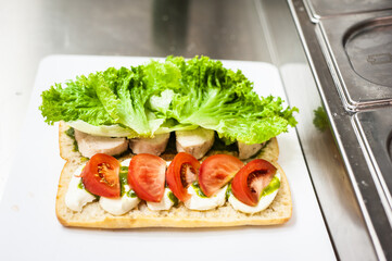 Fresh lettuce with meat and tomatoes for salad or sandwich. Street fast food