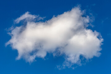 large textured cumulus cloud against blue summer sky as a natural background