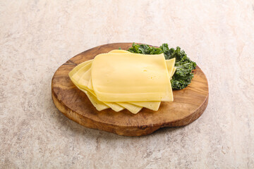 Sliced Gouda cheese over board