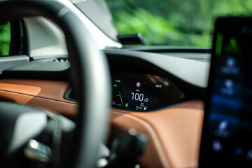 Electric car speedometer dashboard show speed 100 kilometer per hour. Selective focus