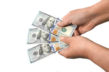 Female hands holding three banknotes of 100 American dollars in cash, isolated on white background