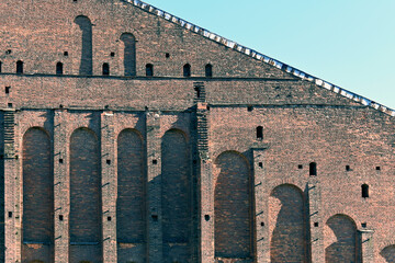 A fragment of the facade of a historical brick building with architectural elements and details in...