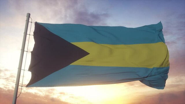Flag of Bahamas waving in the wind, sky and sun background