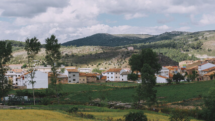 Fototapeta na wymiar Small mountain village in the Alto Tajo National Park. View of the mountains, houses and gardens.