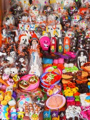 Fototapeta na wymiar Mexican Day of the dead sugar skulls and figurines
