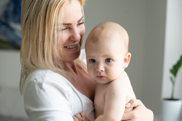 picture of happy mother with baby in hands