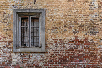 abstract background of red brick wall and broken window of an old abandoned building