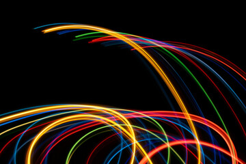colored lines of lights on a black background