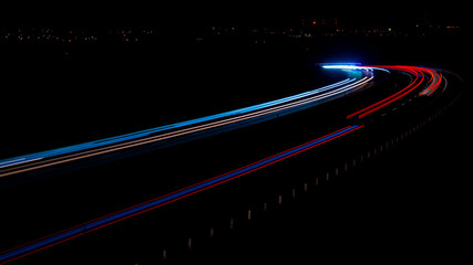 Fototapeta na wymiar Night road lights. Lights of moving cars at night. long exposure red, blue, green