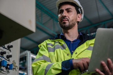 professional technician engineer working to control electrical power and safety service system,...