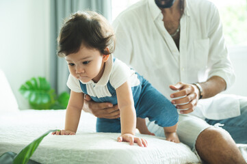 Obraz premium little toddler children with first walk step with stairs at home, small baby person are happy to play and learn to crawling with family, cute infant boy having fun and childhood care