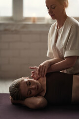 A young woman gets a Thai massage at a spa salon