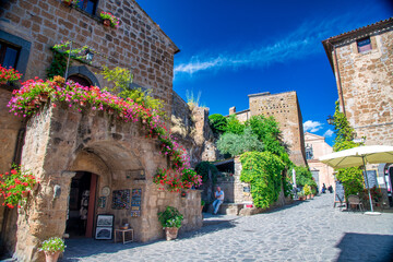 CIVITA DI BAGNOREGIO, ITALY - JULY 2, 2021: Tourists visit famous medieval streets.