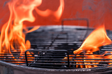 Grill with glowing flames and glowing coals. Charcoal grill for barbecue or barbecue or Bar-B-Q